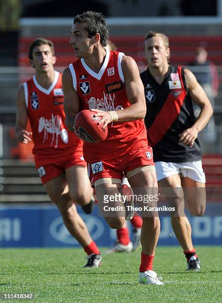 Kane Lucas of the Bullants handballs during the round one VFL match between the Northern Bullants and the Bendigo Bombers at Visy Park on April 2,...
