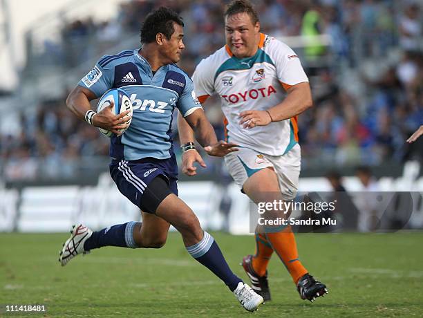 Coenie Oosthuisen of the Cheetahs looks to tackle Isaia Toeava of the Blues during the round seven Super Rugby match between the Blues and the...