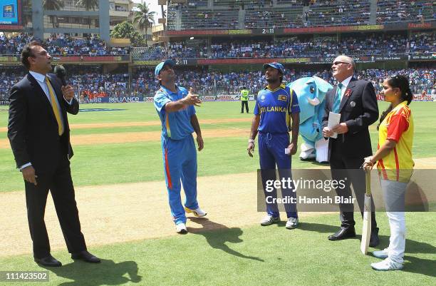 Dhoni of India tosses the coin for the second time with Kumar Sangakkara of Sri Lanka looking on during the 2011 ICC World Cup Final between India...