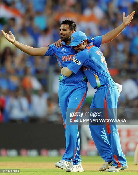 Indian fastbowler Zaheer Khan celebrates with teammate Virat Kohli after taking the wicket of Sri Lankan batsman Chamara Kapugedera during the ICC...