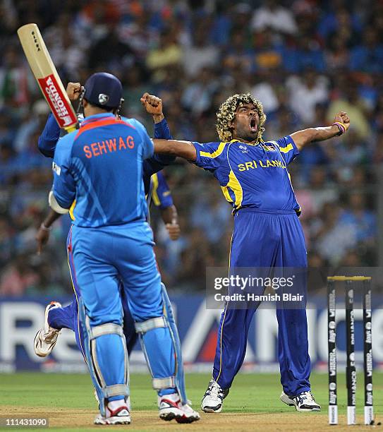 Lasith Malinga of Sri Lanka celebrates the wicket of Virender Sehwag of India during the 2011 ICC World Cup Final between India and Sri Lanka at...