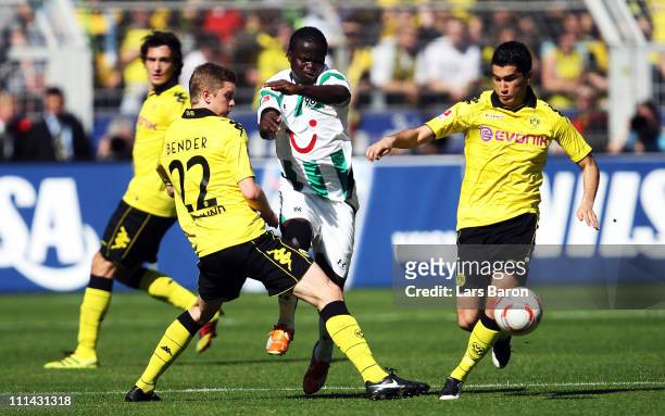 Didier Ya Konan of Hannover is challenged by Sven Bender and Nuri Sahin of Dortmund during the Bundesliga match between Borussia Dortmund and...