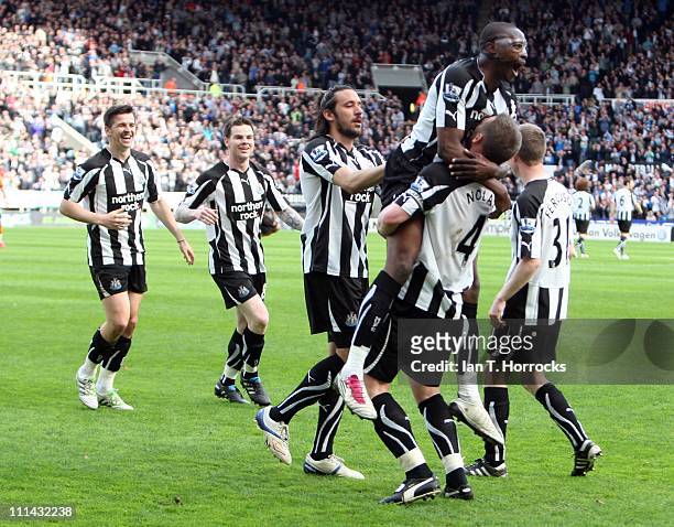 Shola Ameobi celebrates on top of Kevin Nolan after Nolan scored the opening goal during the Barclays Premier League match between Newcastle United...