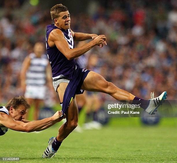 Stephen Hill of the Dockers gets tackled by Darren Milburn of the Cats during the round two AFL match between the Fremantle Dockers and the Geelong...