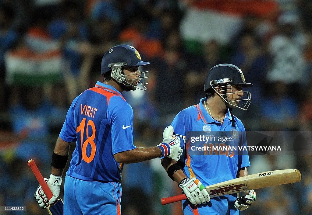 Indian cricketer Virat Kohli (L) pats te