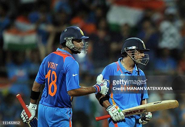 Indian cricketer Virat Kohli pats teammate Gautam Gambhir during the ICC Cricket World Cup 2011 Final match at The Wankhede Stadium in Mumbai on...