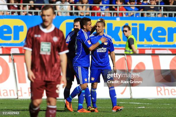 Sidney Sam of Leverkusen celebrates his team's first goal with team mates Arturo Vidal and Hanno Balitsch during the Bundesliga match between 1. FC...