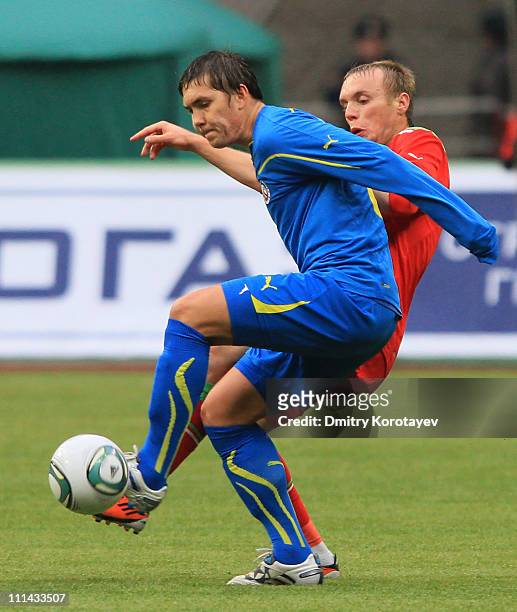 Denis Glushakov of FC Lokomotiv Moscow battles for the ball with Aleksei Rebko of FC Rostov during the Russian Football League Championship match...