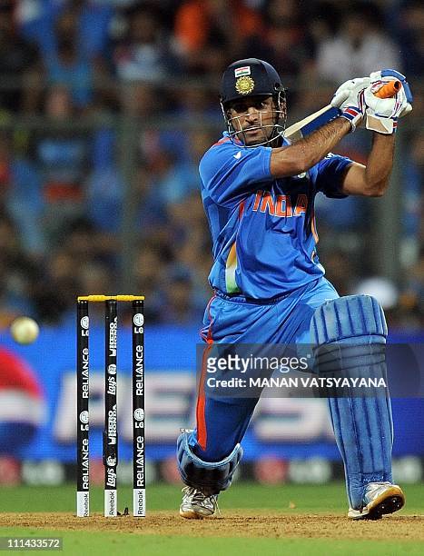 Indian cricket captain Mahendra Singh Dhoni plays a shot during the ICC Cricket World Cup 2011 Final match at The Wankhede Stadium in Mumbai on April...