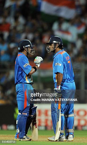 Indian batsmen Gautam Gambhir and Mahendra Singh Dhoni talk during the ICC Cricket World Cup 2011 Final match at The Wankhede Stadium in Mumbai on...