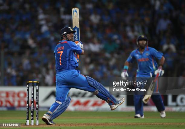 Mahendra Singh Dhoni of India hits a six during the 2011 ICC World Cup Final between India and Sri Lanka at the Wankhede Stadium on April 2, 2011 in...