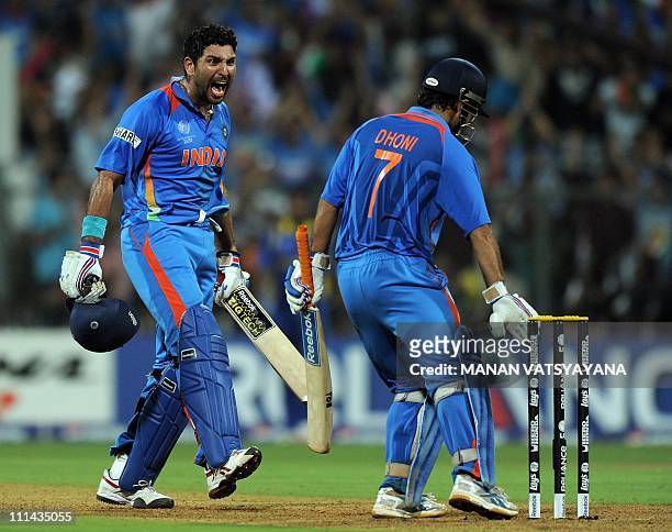 Indian cricket captain Mahendra Singh Dhoni and teamamte Yuvraj Singh celebrate after beating Sri Lanka during the ICC Cricket World Cup 2011 final...