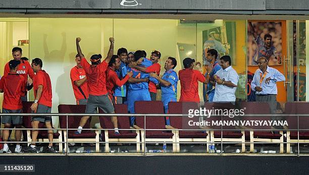 Indian cricketers and coaching staff celebrate after beating Sri Lanka during the ICC Cricket World Cup 2011 final match at The Wankhede Stadium in...