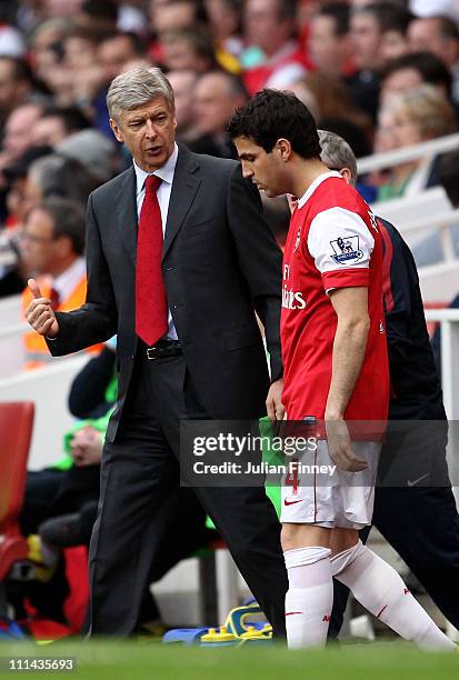 Arsenal manager Arsene Wenger talks to Cesc Fabregas of Arsenal as he prepares to go on during the Barclays Premier League match between Arsenal and...
