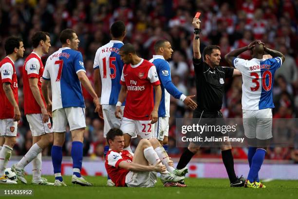 Referee Phil Dowd shows a red card to Steven Nzonzi of Blackburn during the Barclays Premier League match between Arsenal and Blackburn Rovers at the...