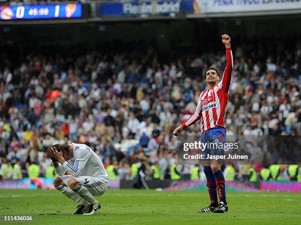 Sergio Ramos of Real Madrid reacts besides Alberto Botia of Sporting Gijon at the end of the la Liga match between Real Madrid and Sporting Gijon at...