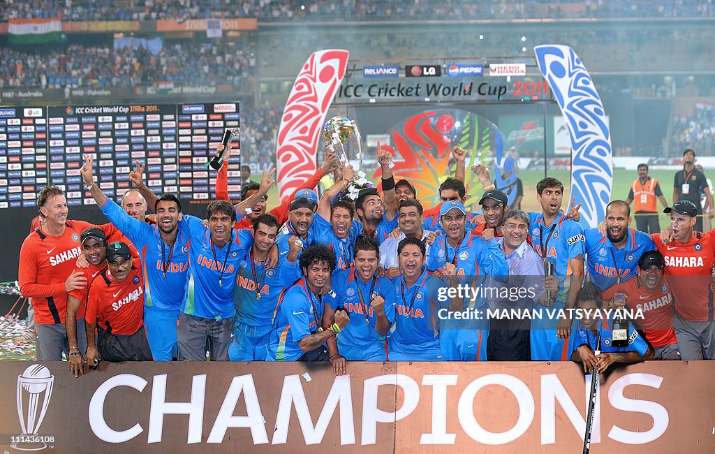 Indian cricketers pose with the trophy a
