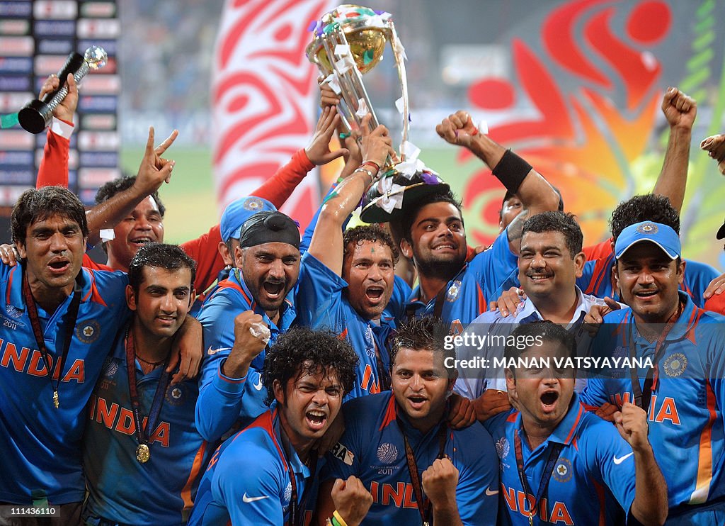 Indian cricketers pose with the trophy a