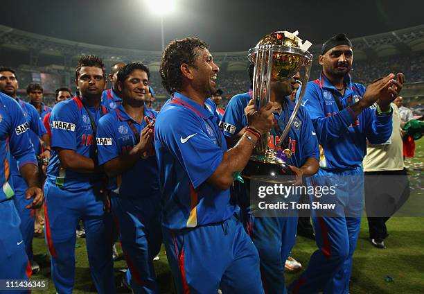 Sachin Tendulkar of India celebrates with the World Cup after beating Sri Lanka during the 2011 ICC World Cup Final between India and Sri Lanka at...