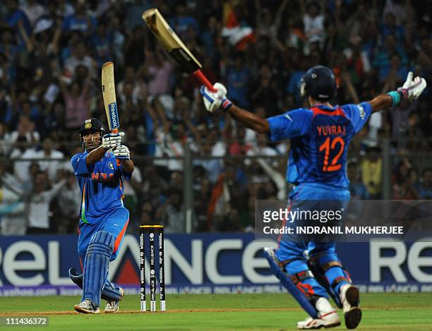 Indian captain Mahendra Singh Dhoni hits a six to win against Sri Lanka as teammate Yuvraj Singh reacts during the Cricket World Cup 2011 final at...
