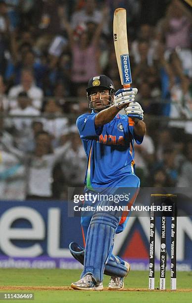 Indian captain Mahendra Singh Dhoni hits a six to win against Sri Lanka during the Cricket World Cup 2011 final at The Wankhede Stadium in Mumbai on...