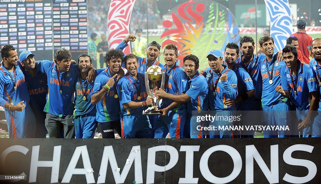 Indian cricketers celebrate with the tro