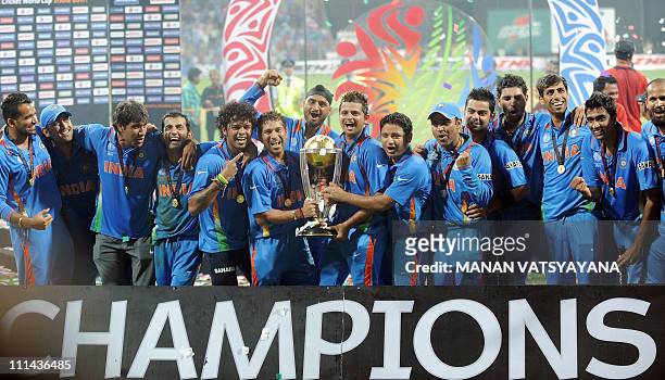 Indian cricketers celebrate with the trophy after beating Sri Lanka in the ICC Cricket World Cup 2011 final match at The Wankhede Stadium in Mumbai...