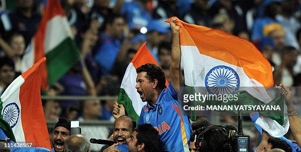 Indian cricketer Sachin Tendulkar is given a lap of honour by teammates after beating Sri Lanka in the ICC Cricket World Cup 2011 final match at The...