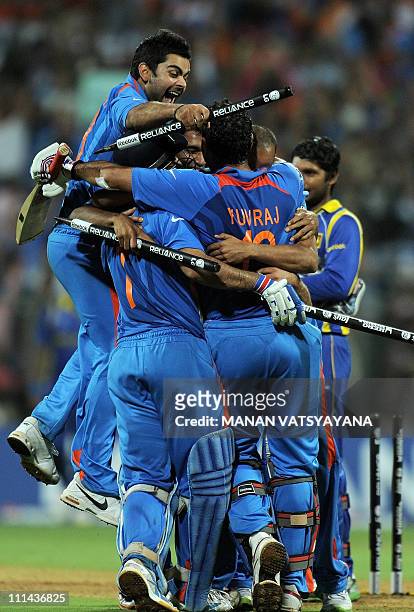Indian cricketers led by Virat Kohli celebrate after beating Sri Lanka during the ICC Cricket World Cup 2011 final match at The Wankhede Stadium in...