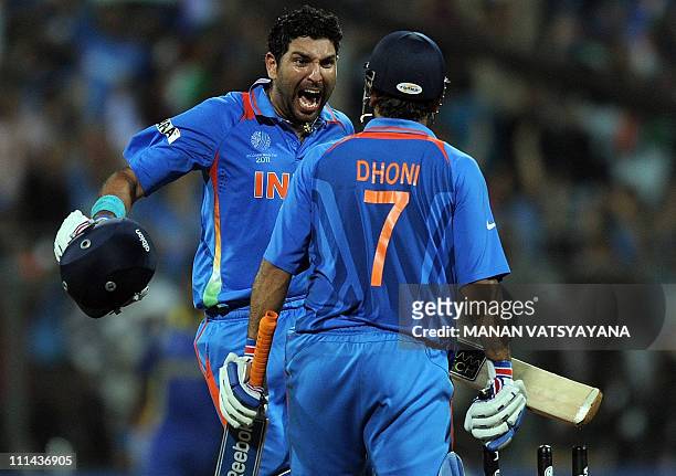 Indian cricketer Yuvraj singh and captain Mahendra Singh Dhoni celebrate after beating Sri Lanka during the ICC Cricket World Cup 2011 final match at...