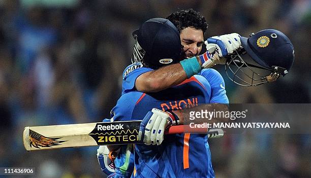 Indian cricketer Yuvraj Singh and captain Mahendra Singh Dhoni celebrate after beating Sri Lanka during the ICC Cricket World Cup 2011 final match at...