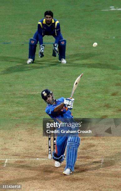 Dhoni, captain of India hits the winning runs watched by Kumar Sangakkara captain of Sri Lanka to secure victory during the 2011 ICC World Cup Final...