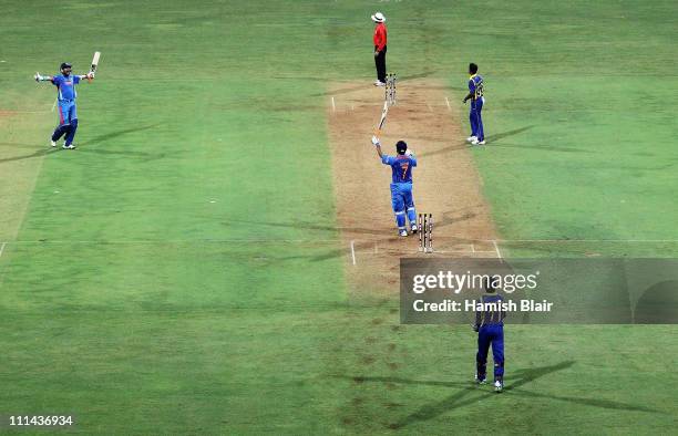 Dhoni and Yuvraj Singh of India celebrate as Dhoni hits a six to win the match during the 2011 ICC World Cup Final between India and Sri Lanka at...