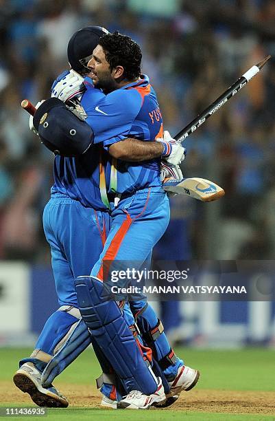 Indian cricketer Yuvraj Singh and captain Mahendra Singh Dhoni celebrate after beating Sri Lanka during the ICC Cricket World Cup 2011 final match at...