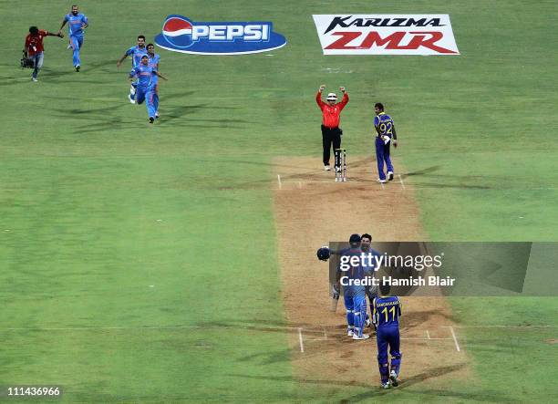 Dhoni and Yuvraj Singh of India celebrate after Dhoni hit a six to win the match during the 2011 ICC World Cup Final between India and Sri Lanka at...