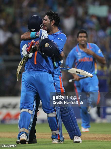 Dhoni and Yuvraj Singh of India celebrate after Dhoni hit a six to win the match during the 2011 ICC World Cup Final between India and Sri Lanka at...