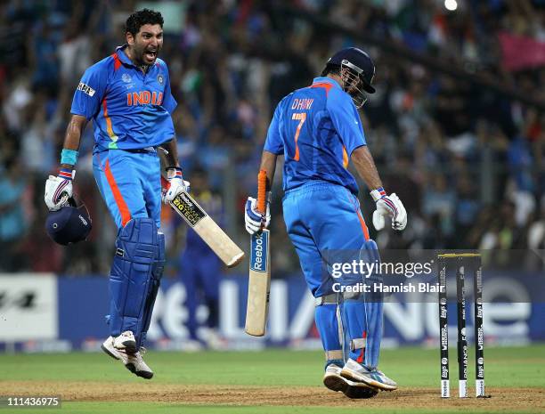 Dhoni and Yuvraj Singh of India celebrate after Dhoni hit a six to win the match during the 2011 ICC World Cup Final between India and Sri Lanka at...