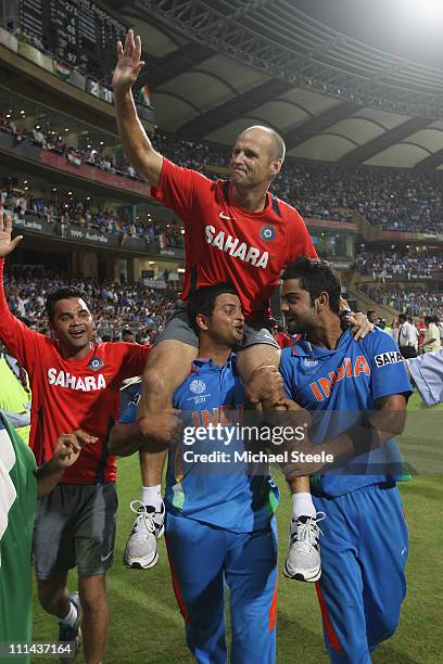 Gary Kirsten the coach of India is lifted by Suresh Raina and Virat Kohli during the 2011 ICC World Cup Final between India and Sri Lanka at Wankhede...