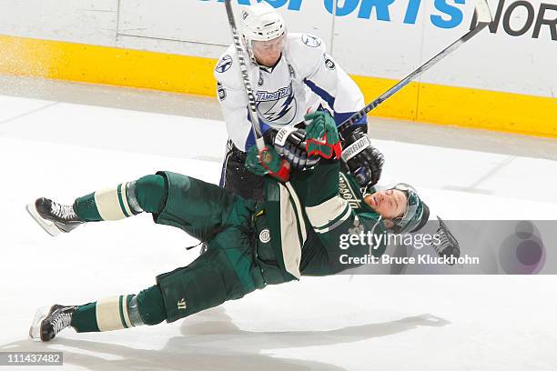 Mattias Ohlund of the Tampa Bay Lightning checks Martin Havlat of the Minnesota Wild during the game at Xcel Energy Center on April 2, 2011 in Saint...