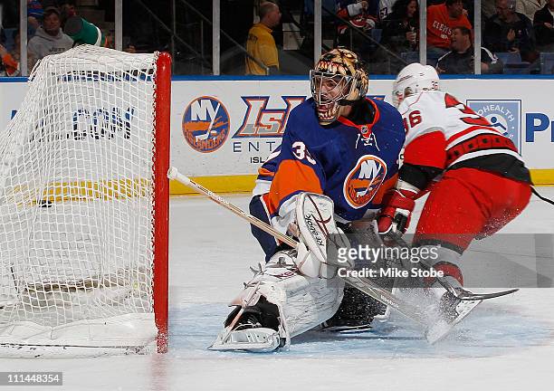 Al Montoya of the New York Islanders watches the puck go into the net on a goal by Jussi Jokinen of the Carolina Hurricanes on April 2, 2011 at...