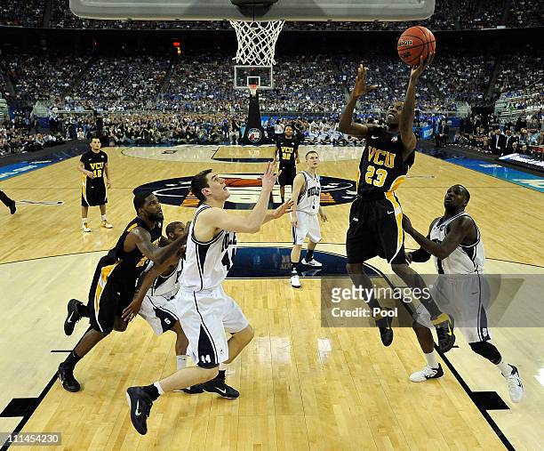 Rob Brandenberg of the Virginia Commonwealth Rams goes to the hoop against Andrew Smith of the Butler Bulldogs during the National Semifinal game of...