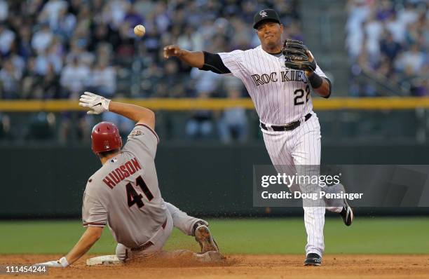 Second baseman Jose Lopez of the Colorado Rockies gets a force out on Daniel Hudson of the Arizona Diamondbacks at second base but was unable to turn...