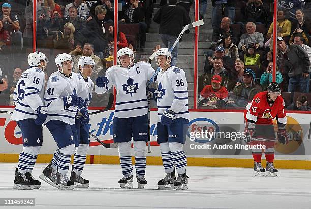 Bobby Butler of the Ottawa Senators looks on as Clarke MacArthur, Nikolai Kulemin, Mikhail Grabovski, Dion Phaneuf and Carl Gunnarsson of the Toronto...