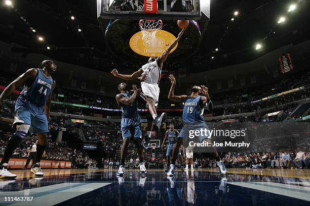 Leon Powe of the Memphis Grizzlies shoots over Wayne Ellington of the Minnesota Timberwolves on April 2, 2011 at FedEx Forum in Memphis, Tennessee....