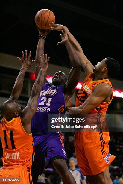 Moses Ehambe of the Iowa Energy tries to shoot over the defense of Abdulai Jalloh and Josh Bostic of the New Mexico Thunderbirds during the game on...