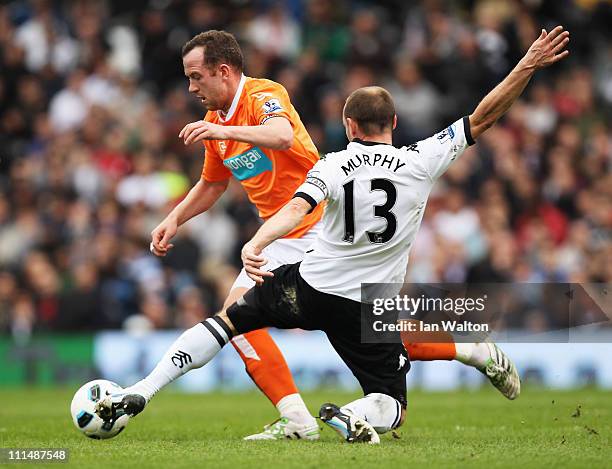 Danny Murphy of Fulham tackles Charlie Adam of Blackpool during the Barclays Premier League match between Fulham and Blackpool at Craven Cottage on...