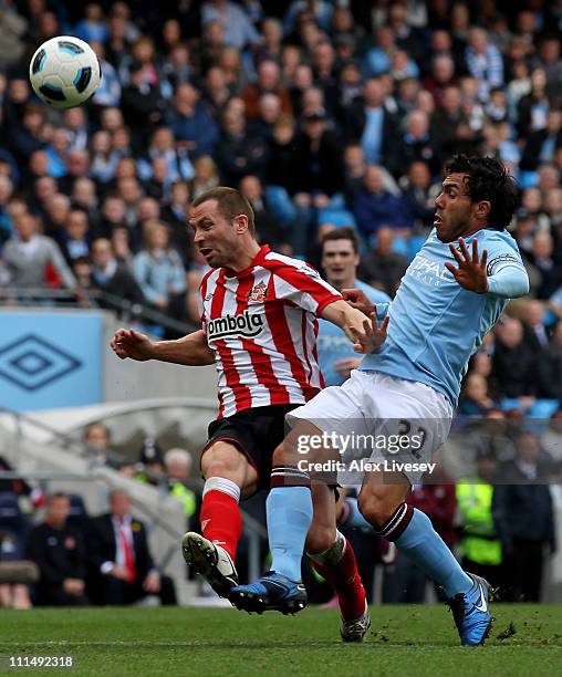 Carlos Tevez of Manchester City is fouled by Phil Bardsley of Sunderland to concede a penalty during the Barclays Premier League match between...