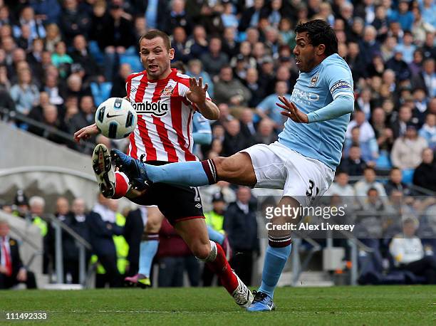 Carlos Tevez of Manchester City is fouled by Phil Bardsley of Sunderland to concede a penalty during the Barclays Premier League match between...