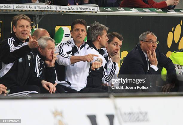 Head coach Felix Magath , asisstent coach Bernd Hollerbach and Assistent coach Pierre Littbarski of Wolfsburg are seen during the Bundesliga match...
