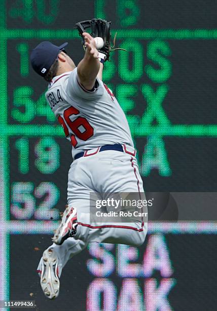 Second baseman Dan Uggla of the Atlanta Braves catches a hit by Ian Desmond of the Washington Nationals for an out during the sixth inning at...